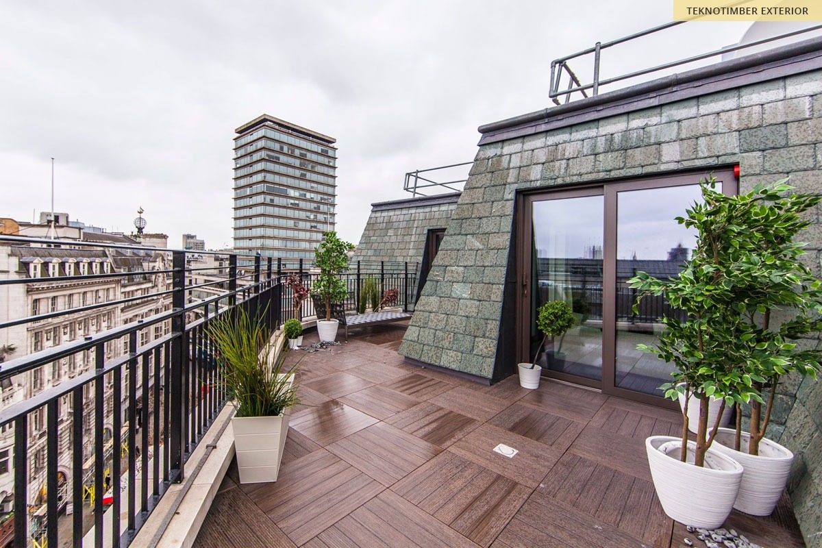 A London rooftop terrace at dusk overlooking the city
