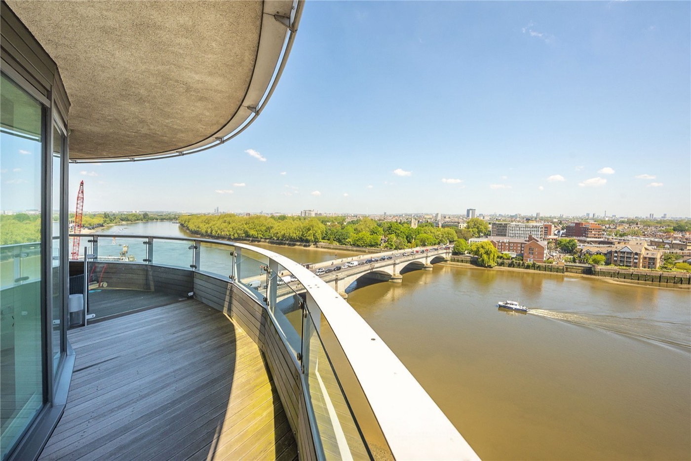 A riverside balcony view over Putney Bridge and the Thames